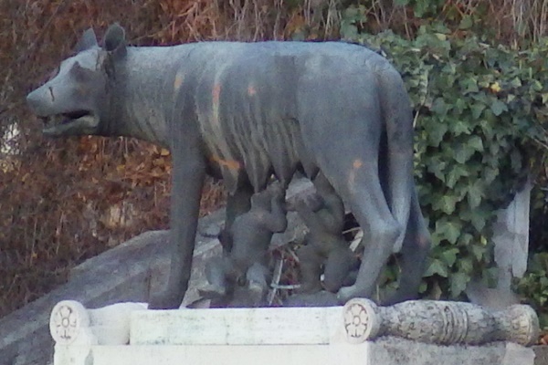 A statue of a wolf nursing human children.